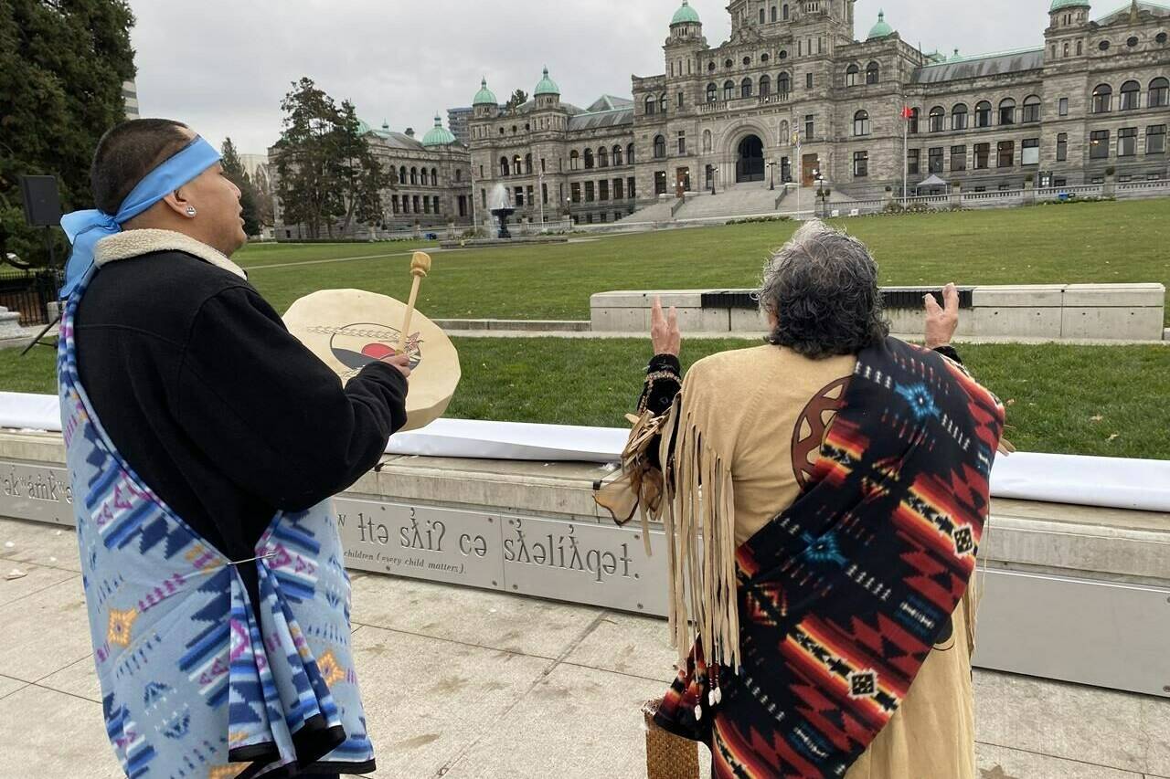 Elder Mary Ann Thomas and Charlie George, of the B.C. Association of Aboriginal Centres, welcome the new Indigenous signage unveiled on the grounds of the B.C. legislature, once the site of an Indigenous village, in Victoria on Wednesday Nov. 29, 2023. THE CANADIAN PRESS/Dirk Meissner
