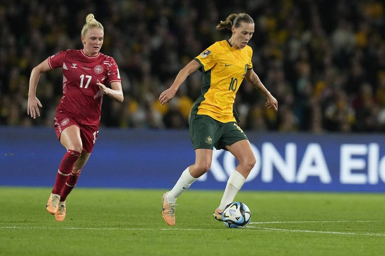Australia's Emily Van Egmond, right, controls the ball during the Women's World Cup round of 16 soccer match between Australia and Denmark at Stadium Australia in Sydney, Australia, Monday, Aug. 7, 2023. THE CANADIAN PRESS/AP-Mark Baker
