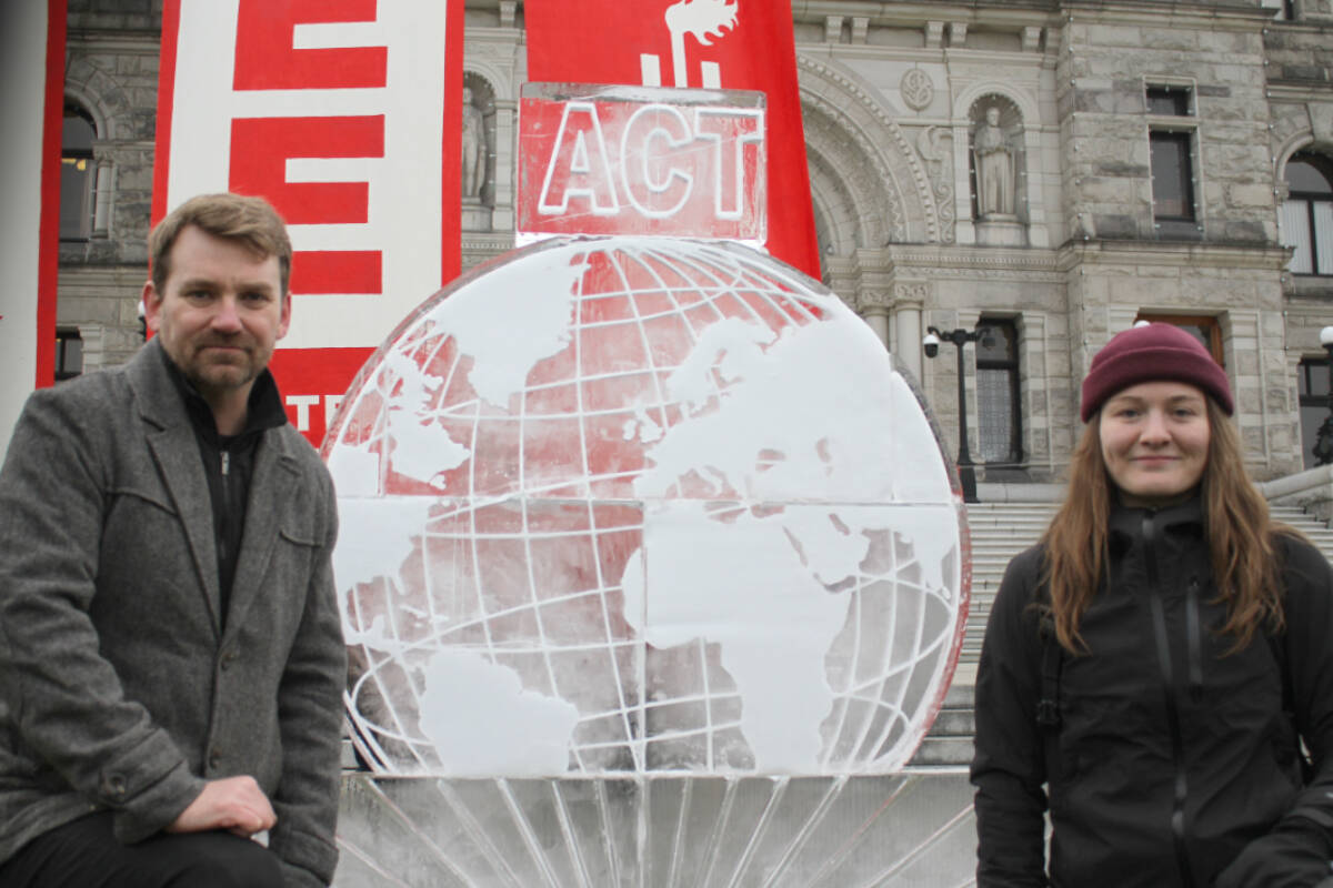 Left to right, Mike Hudema and Mary Stuart member of Climate Justice Victoria stand beside massive ice sculpture at climate protest. (Ella Matte/News Staff)