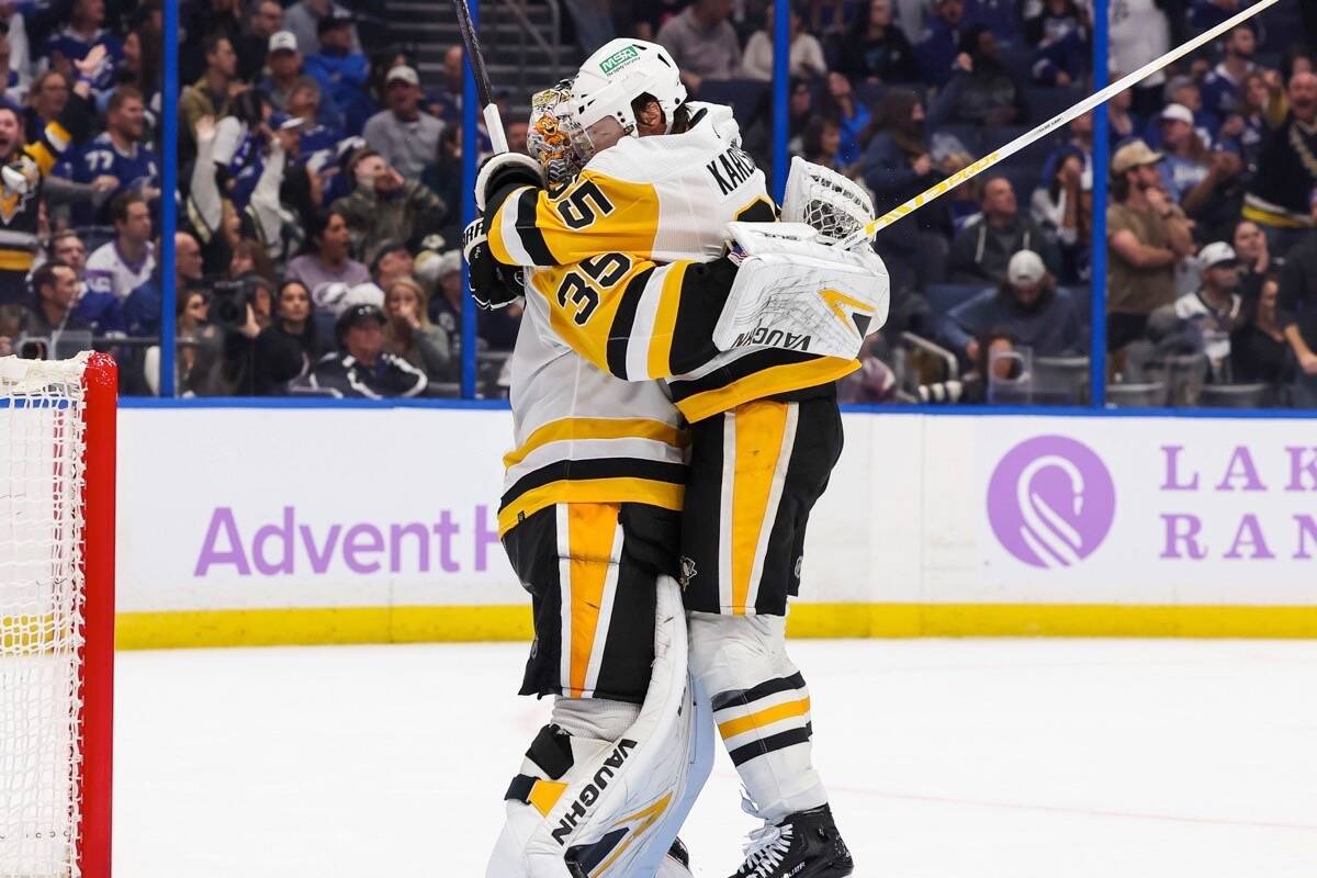 Pittsburgh Penguins goalie Tristan Jarry embraces teammate Erik Karlsson after the netminder scored the franchise’s first-ever “goalie goal” in the final minutes of the team’s 4-2 win over the Tampa Bay Lightning on Thursday, Nov. 30, 2023. (twitter.com/penguins photo)