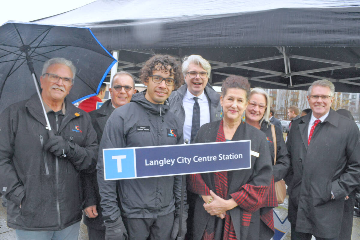 Langley City council members Paul Albrecht (left), Leith White, Mayor Nathan Pachal, Rosemary Wallace and Teri James, along with Langley MP Andrew Merciaer (rear centre) and Cloverdale-Langley City MP John Aldag (right) were at the SkyTrain announcement Friday, Dec. 1, 2023. (Heather Colpitts/Black Press Media)