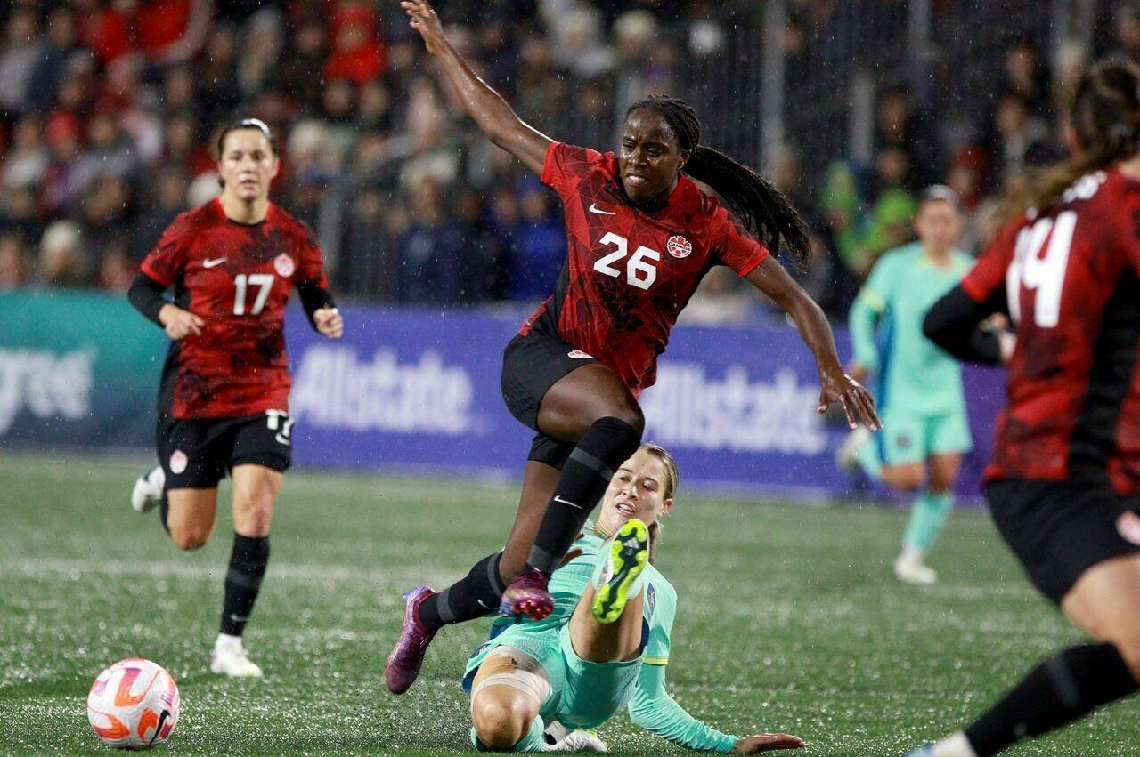 Canada’s Simi Awujo avoids a tackle by Australia’s Courtney Nevin during first half soccer action at Starlight Stadium in Langford, B.C., on Friday, December 1, 2023. THE CANADIAN PRESS/Chad Hipolito