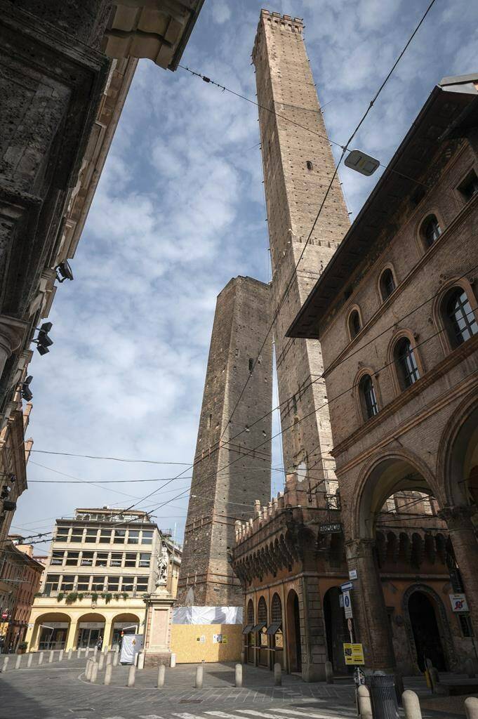 The Garisenda, left, and Asinelli towers are pictured in Bologna, Italy, March 20, 2020. Bologna’s Garisenda tower has been locked down for fear it could collapse. Authorities have provided a security cordon in case of collapse.The Garisenda tower along with the Asinelli(97meters)tower is one of the beauties and attractions for tourists visiting Bologna, and a landmark for citizens. (Massimo Paolone, Lapresse Via AP)