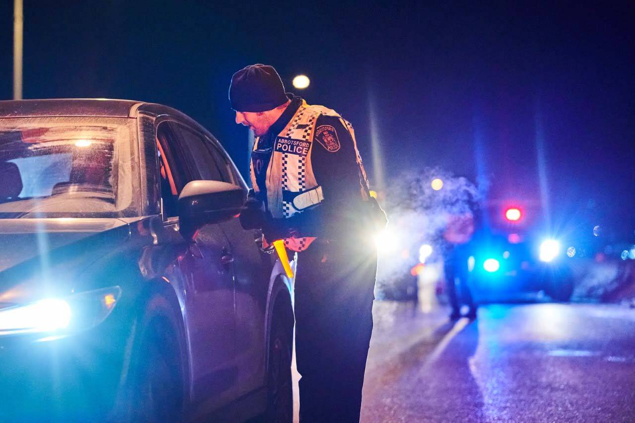 An officer with the Abbotsford Police Department stops a driver during last year’s campaign on Dec. 3, 2022. This year, nearly 250 officers will be stopping drivers at all Highway 1 exits from the North Shore to Hope. (Photo by Dale Klippenstein)