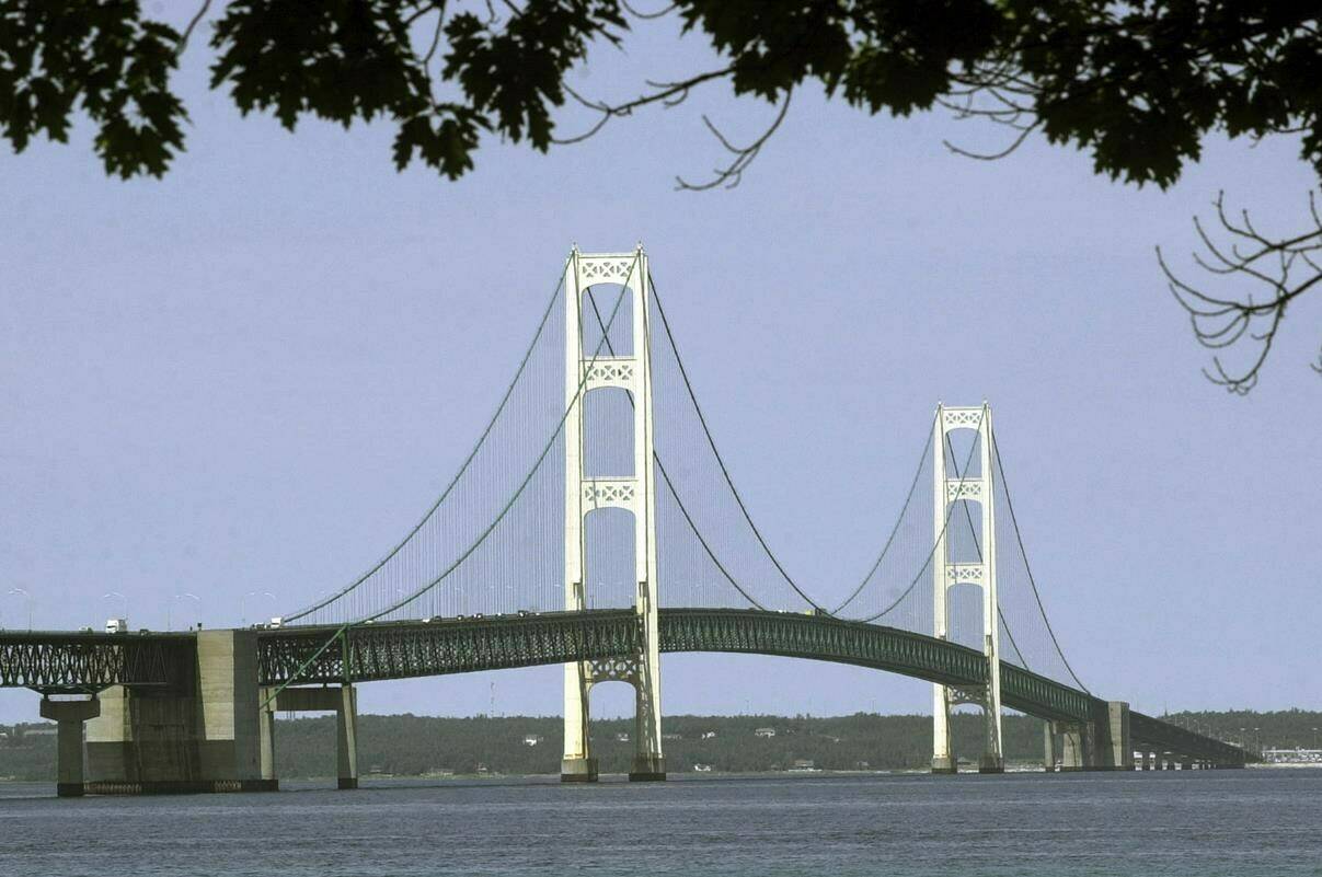 FILE - This July 19, 2002, file photo, shows the Mackinac Bridge that spans the Straits of Mackinac from Mackinaw City, Mich. Michigan regulators have approved a $500 million plan to encase a portion of an oil pipeline that runs beneath a channel connecting two Great Lakes. The state Public Service Commission on Friday, Dec. 1, 2023, approved the proposal for the tunnel through the Straits of Mackinac. (AP Photo/Carlos Osorio, File)