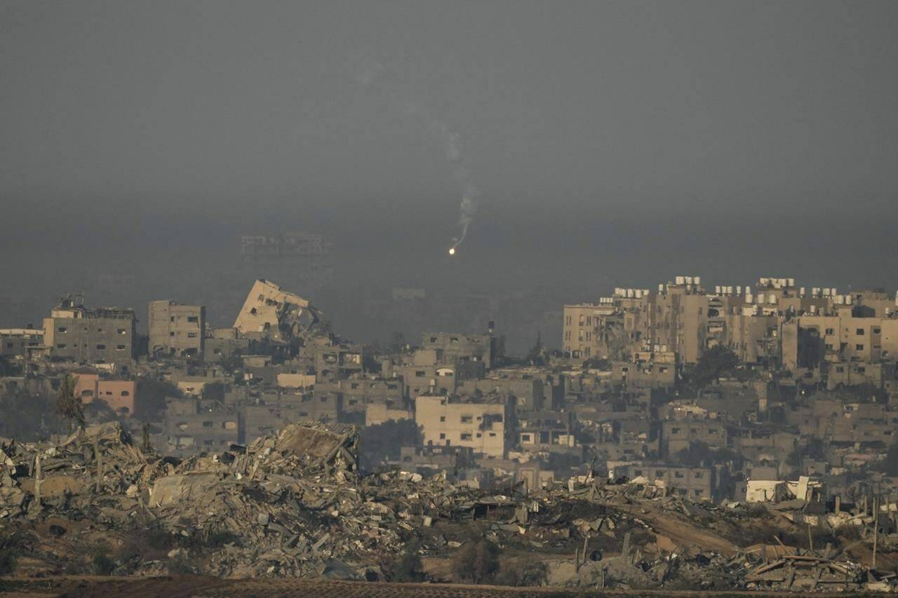 An Israeli army flare is seen over the Gaza Strip, as seen from southern Israel, Sunday, Dec. 3, 2023. Global Affairs Canada is announcing the death of an eighth Canadian citizen in the Israel-Hamas war. THE CANADIAN PRESS/AP, Leo Correa