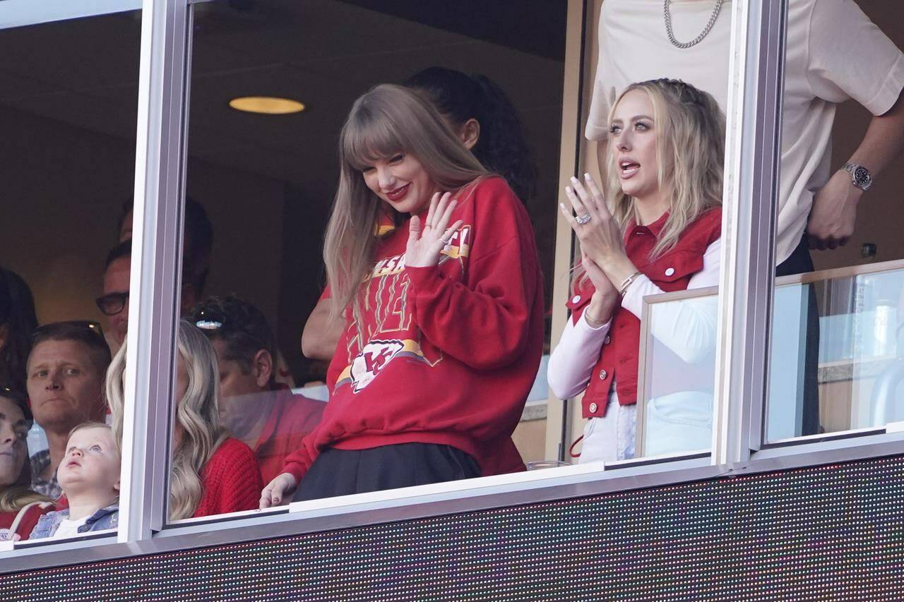 FILE - Taylor Swift waves from a suite alongside Brittany Mahomes, right, during the first half of an NFL football game between the Kansas City Chiefs and the Los Angeles Chargers, Oct. 22, 2023, in Kansas City, Mo. (AP Photo/Ed Zurga, File)