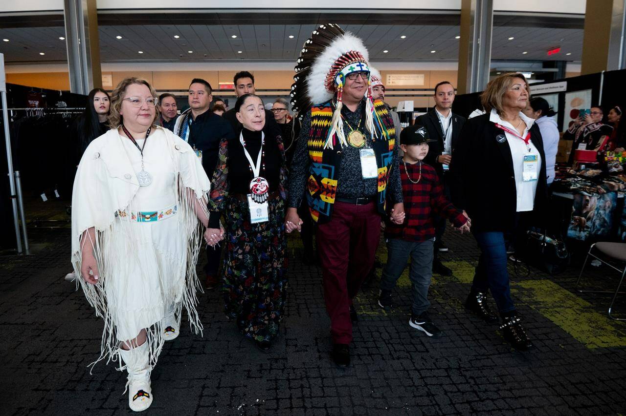 Cindy Woodhouse, left, interim national chief Joanna Bernard, second left, and David Pratt, centre, walk towards the main stage during the third day of National Chief of the Assembly of First Nations during the third day of the Special Chiefs Assembly in Ottawa, on Thursday, Dec. 7, 2023. Woodhouse is the new national chief of the Assembly of First Nations. THE CANADIAN PRESS/Spencer Colby