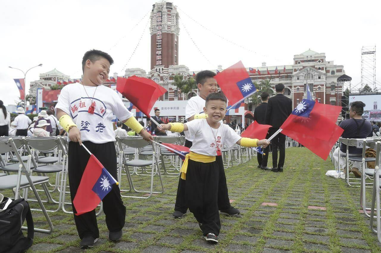 Taiwan is enjoying a spike in prominence in Canadian discourse in the past year, which experts attribute to several geopolitical reasons. Children wave Taiwan’s national flags during National Day celebrations in front of the Presidential Building in Taipei, Taiwan, Tuesday, Oct. 10, 2023. THE CANADIAN PRESS/AP-Chiang Ying-ying