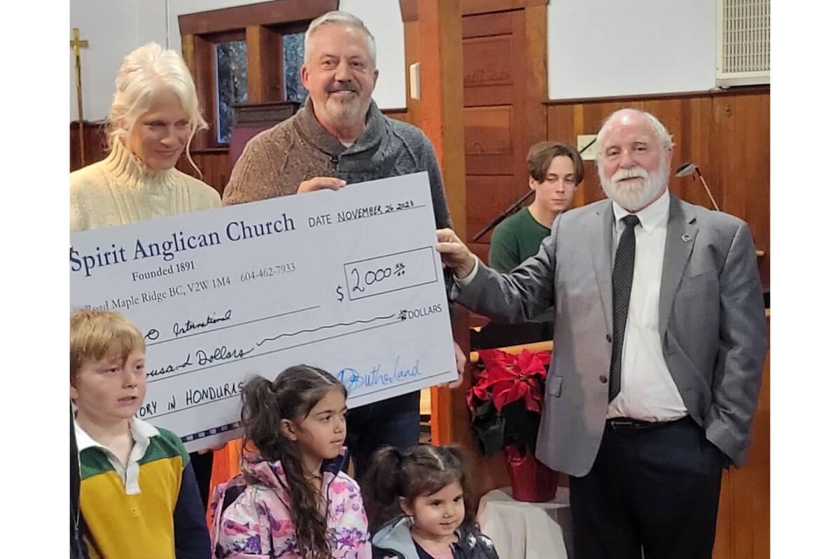 Michelle and Brent presented with a cheque for $2,000 from Holy Spirit Anglican Church in Whonnock. (Amparo International/Special to The News)