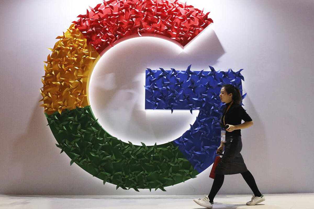 A woman walks past the logo for Google at the China International Import Expo in Shanghai, Nov. 5, 2018. (AP Photo/Ng Han Guan, File)