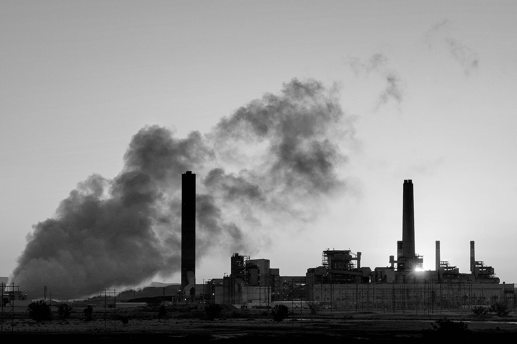 In this July 27, 2018 photo, the Dave Johnson coal-fired power plant is silhouetted against the morning sun in Glenrock, Wyo. (AP Photo/J. David Ake)