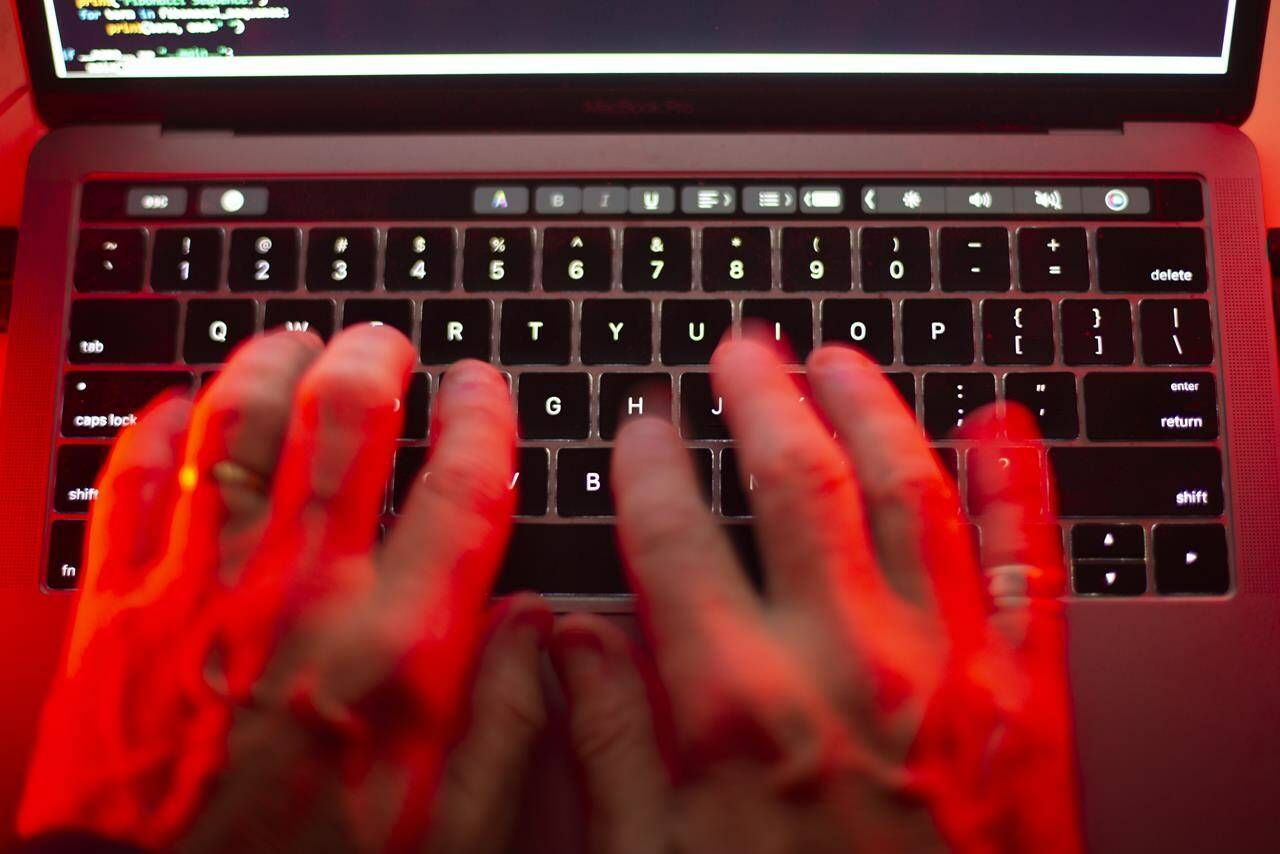 Violent extremists who lack the means to carry out an attack in Canada could compensate by perpetrating hoaxes with the help of artificial intelligence, says a newly released analysis. A man uses a computer keyboard in Toronto in this Sunday, Oct. 9, 2023 photo illustration. THE CANADIAN PRESS/Graeme Roy