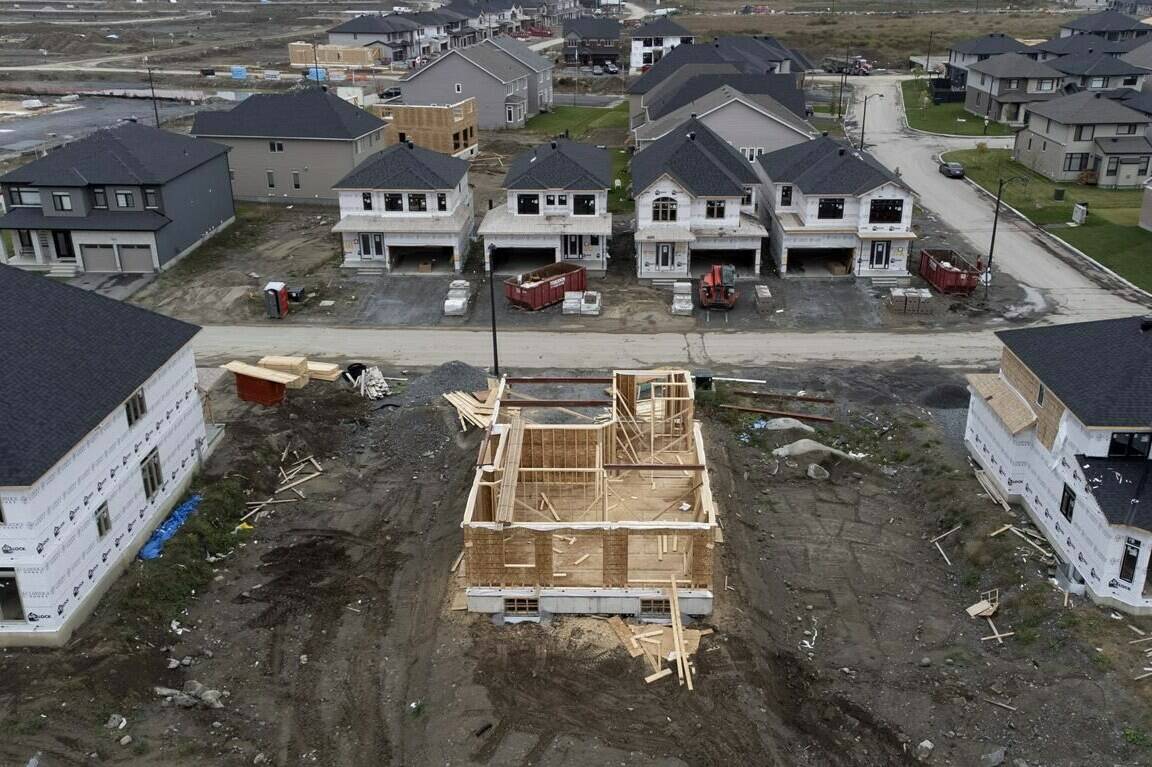 Canada Mortgage and Housing Corp. says the annual pace of housing starts fell 22 per cent in November. In this photo taken using a drone, homes under construction are seen in a new suburb, Friday, Oct. 15, 2021 in Ottawa. THE CANADIAN PRESS/Adrian Wyld