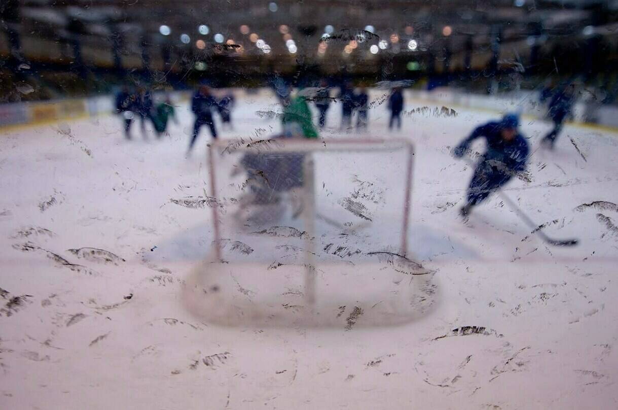 An 11-year-old boy has died after getting hit by a hockey puck during a junior hockey league practice event near Montreal on Tuesday. Rubber marks from pucks dot the glass at a hockey practice in Vancouver on Thursday, June 2, 2011. THE CANADIAN PRESS/Darryl Dyck