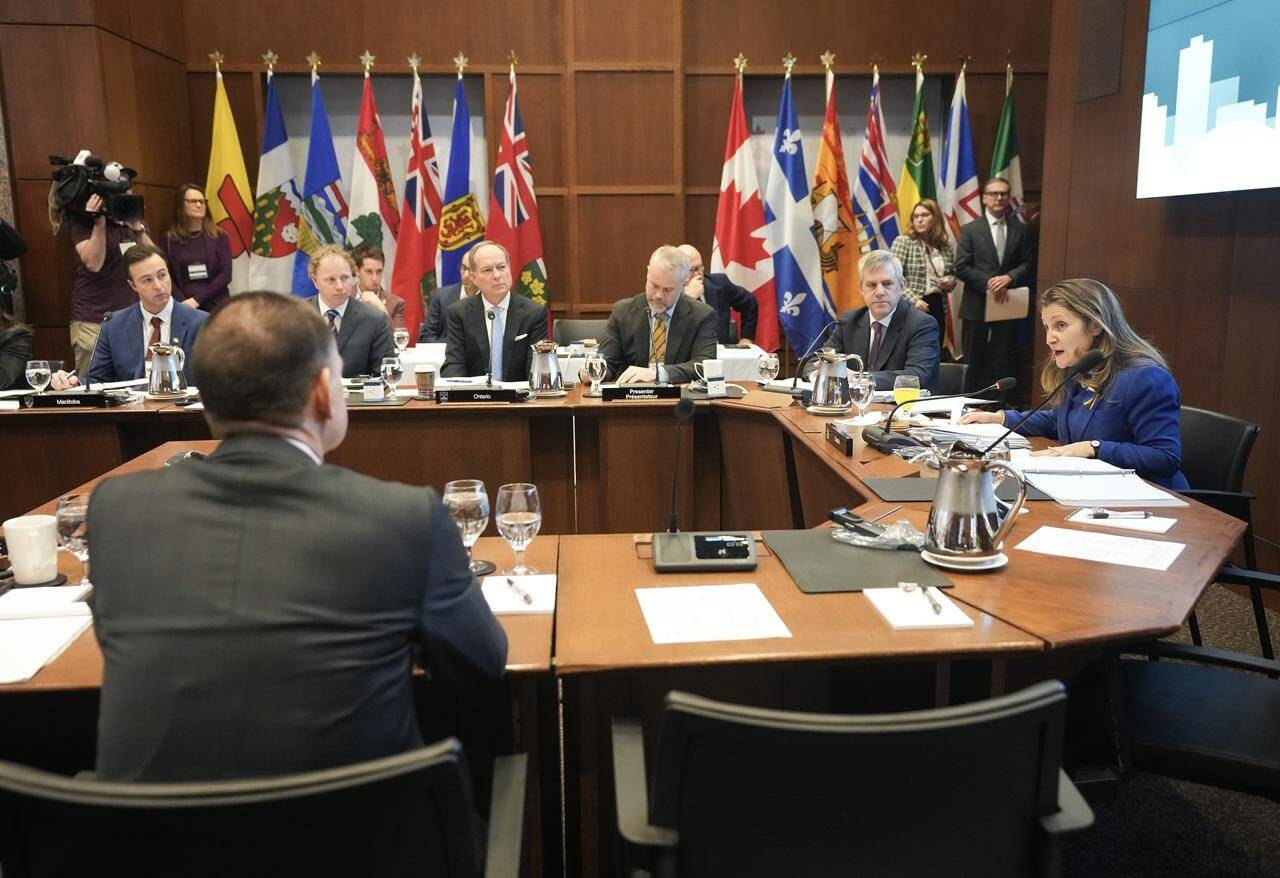 Chrystia Freeland, Canada’s Deputy Prime Minister and Minister of Finance, right, speaks as she hosts the annual meeting of federal, provincial, and territorial finance ministers in Toronto on Friday, December 15, 2023. THE CANADIAN PRESS/Nathan Denette