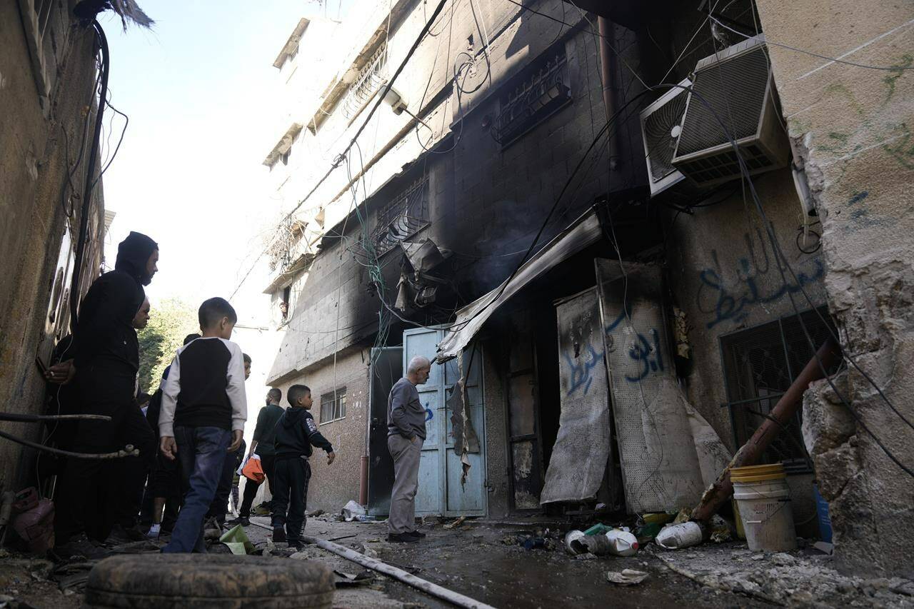 Palestinians look at the aftermath of the Israeli military raid on Nur Shams refugee camp in the West Bank on Sunday, Dec. 17, 2023. (AP Photo/Majdi Mohammed)