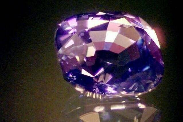 FILE - An 8.8 carat purple sapphire appears at John Marshall’s jewelry shop in South Bend, Ind., May, 1, 1998. (AP Photo/Jim Rider, File)