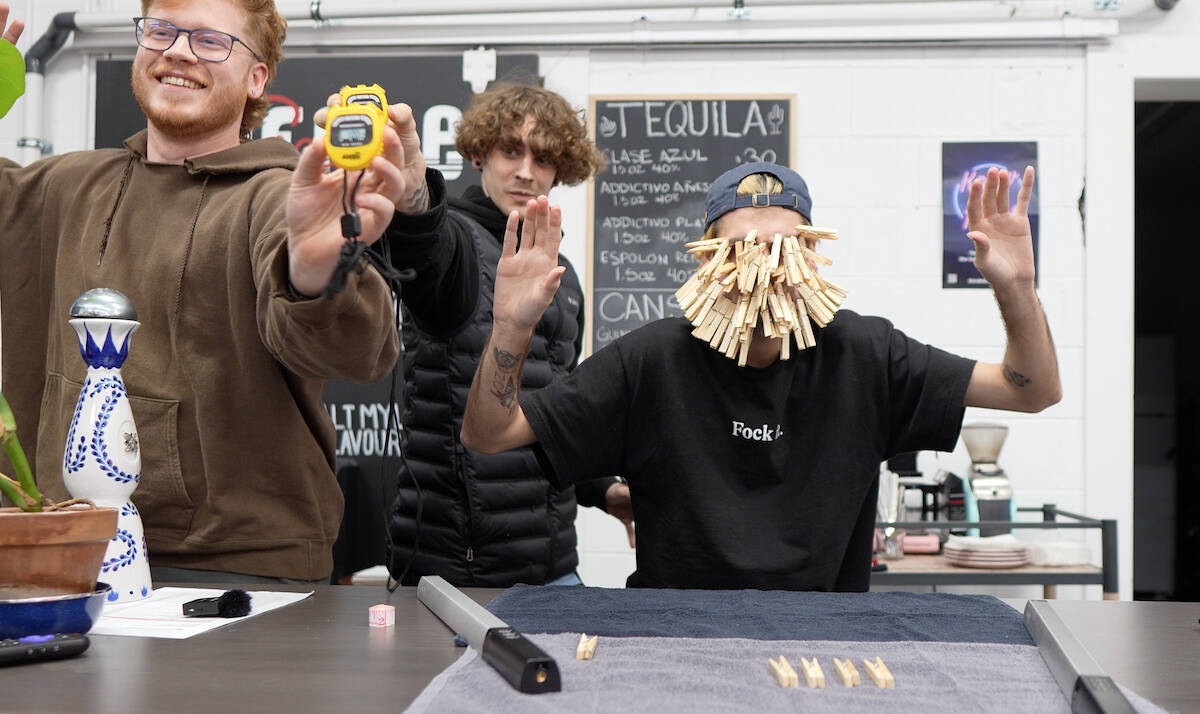 Jacob Hillhouse clipped 52 clothespins to his face Society Barbershop in Duncan on Dec. 7, breaking the former record of 51 which had been held since 2013. Riley Ingham, left, and Trevor Clemente kept time and Hillhouse honest at the record breaking fun event which was held at Society Barbershop on Dec. 7. (Submitted photo)