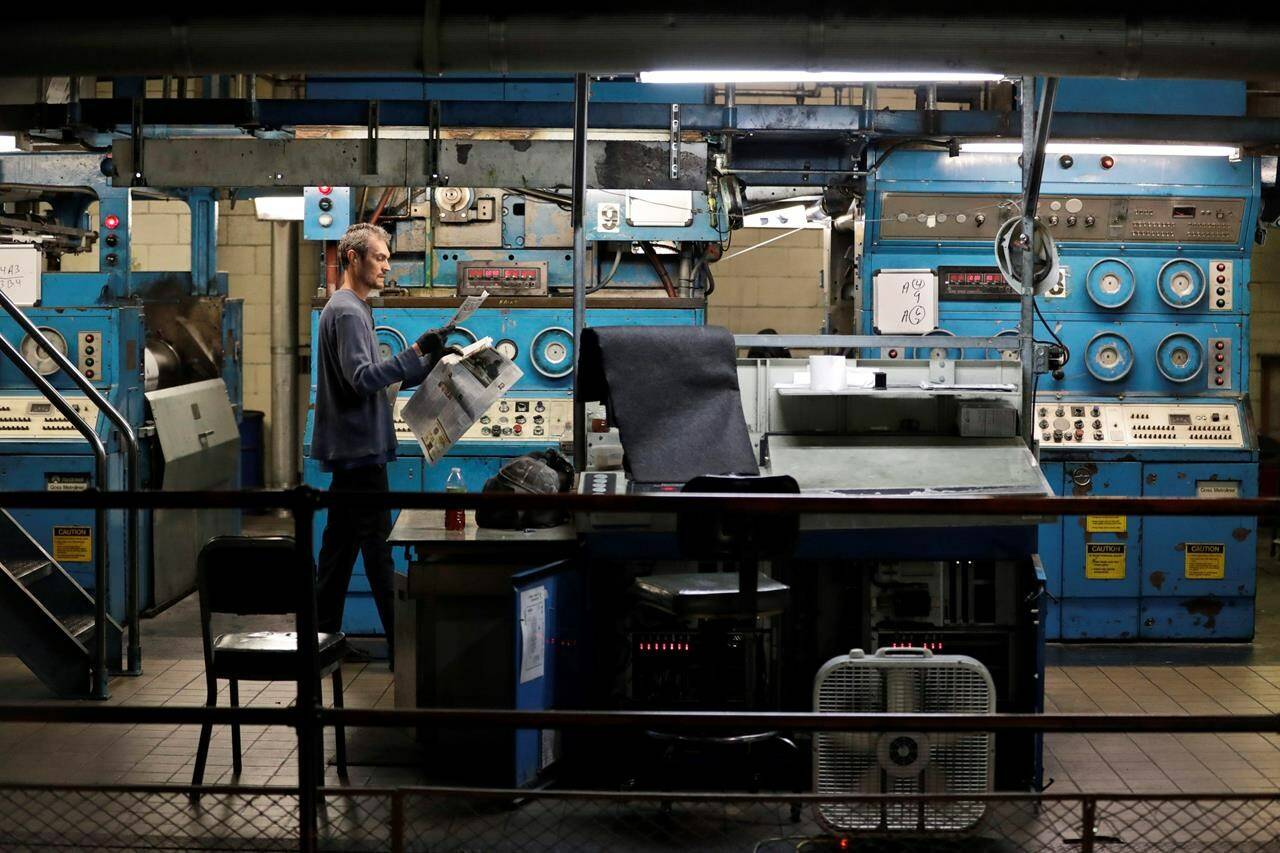 A press operator looks over the registration and color of a newspaper in Youngstown, Ohio on Aug.7, 2019. There was a flurry of closures of local Canadian newsrooms in 2023 that left municipal governments, non-profits and journalists themselves trying to figure out what’s next.THE CANADIAN PRESS/AP-Tony Dejak