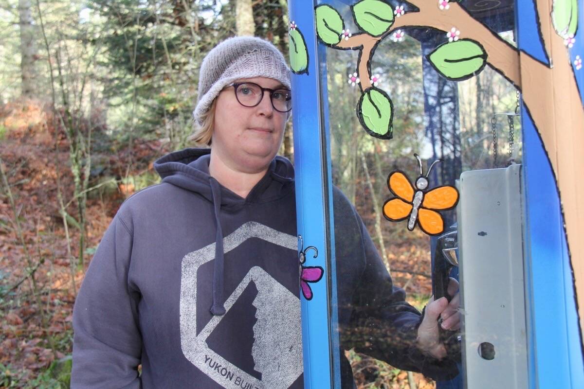 Amanda Farrell-Low with the wind phone at Royal Oak Burial Park in Saanich. She led the initiative to have the phone installed, spurred by the loss of her brother in 2012. (Christine van Reeuwyk/News Staff)