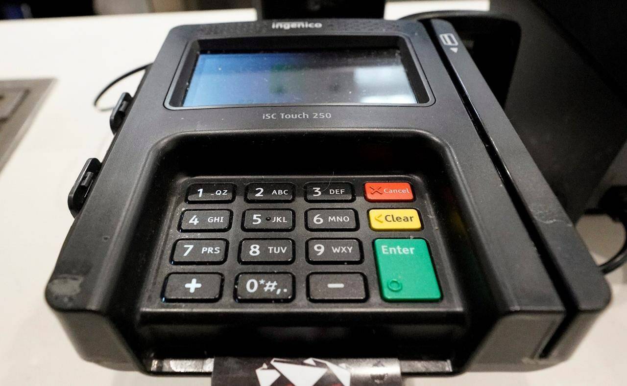 A credit card machine is shown at Mercedes-Benz Stadium during a tour, in Atlanta. Moneris, which operates credit and debit machines in Canada, is reporting a widespread service issue on Saturday, Dec. 23, 2023. THE CANADIAN PRESS/AP-David J. Phillip