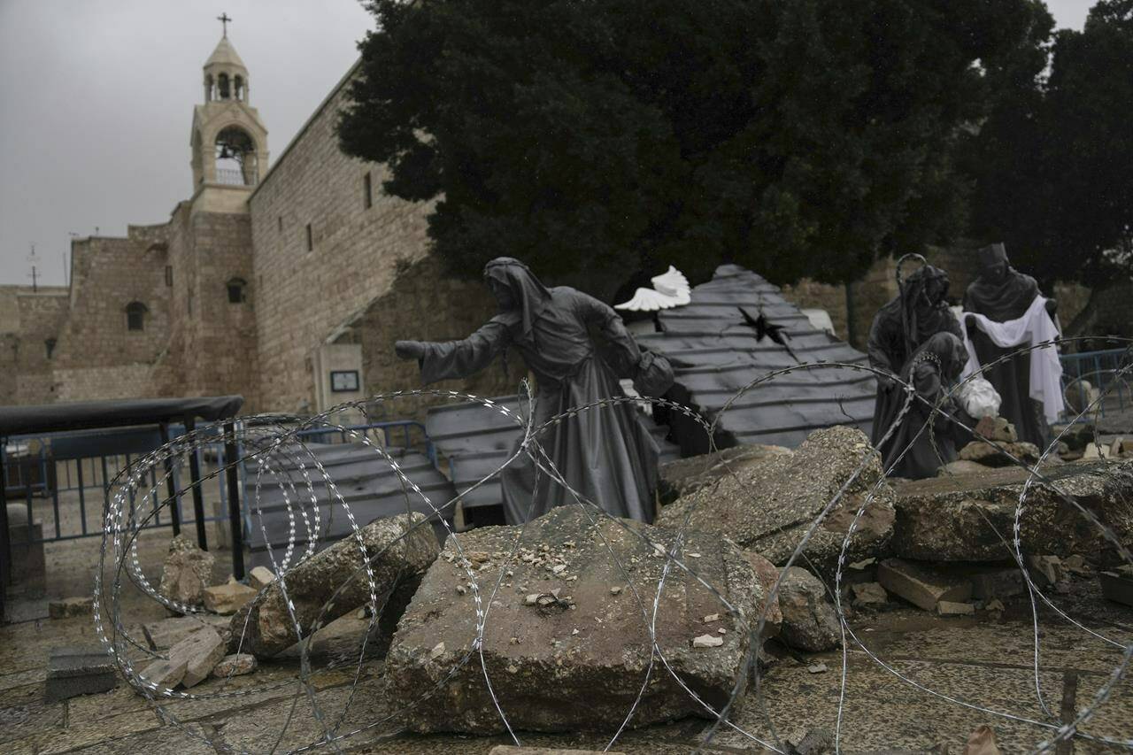 A nativity scene decorated to honor the victims in Gaza is displayed in Manger Square, near the Nativity Church, which is traditionally believed to be the birthplace of Jesus, on Christmas Eve, in the West Bank city of Bethlehem, Sunday, Dec. 24, 2023. Bethlehem is having a subdued Christmas after officials in Jesus’ traditional birthplace decided to forgo celebrations due to the Israel-Hamas war. (AP Photo/Mahmoud Illean)