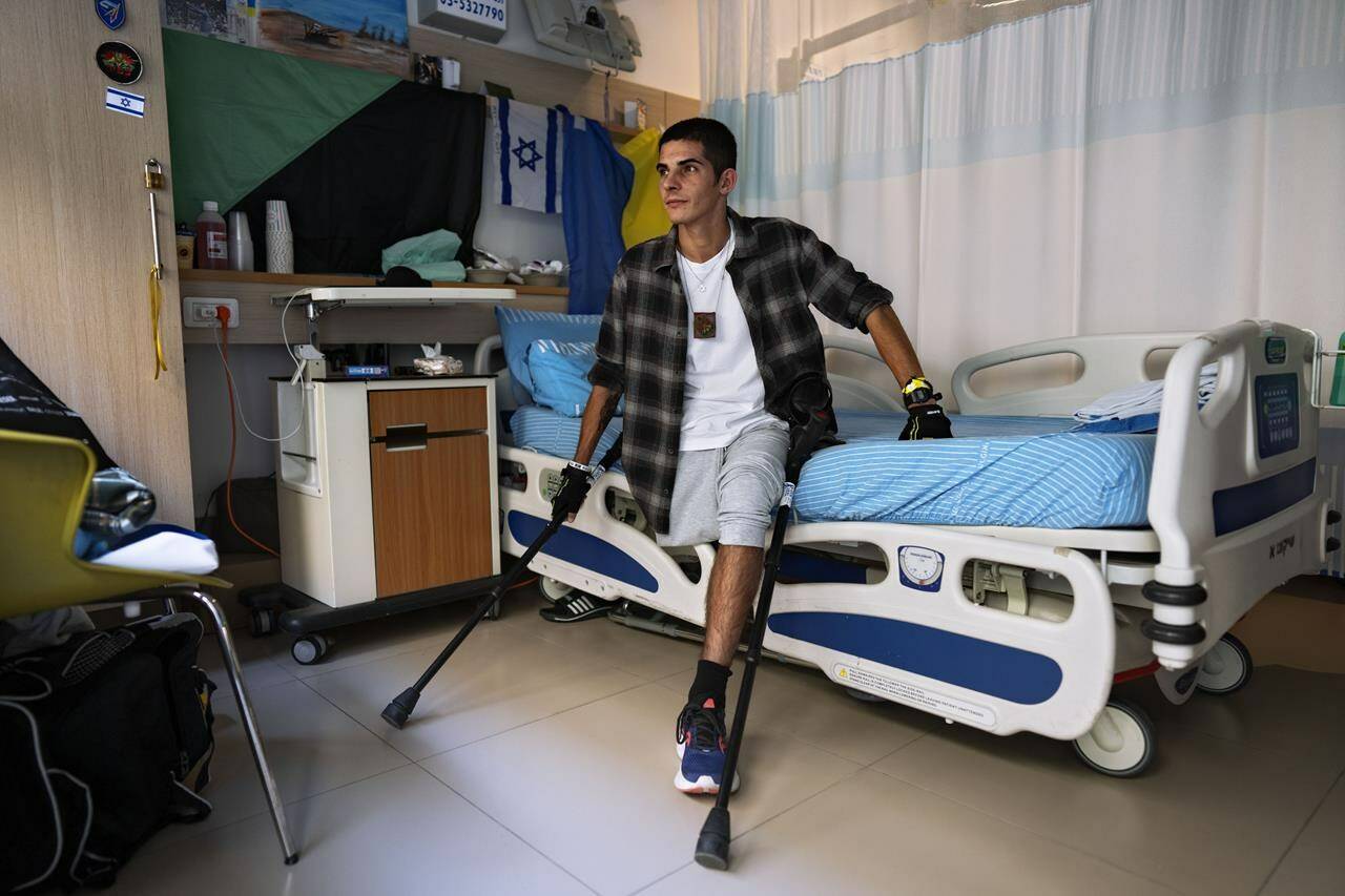 Israeli reservist Igor Tudoran, 27, wounded in the war with Hamas, sits in his room at Sheba hospital’s rehabilitation division, in Ramat Gan, Israel, Monday, Dec. 18, 2023. Tudoran was wounded in the Gaza Strip when a missile fired by militants in Gaza slammed into his tank. (AP Photo/Oded Balilty)