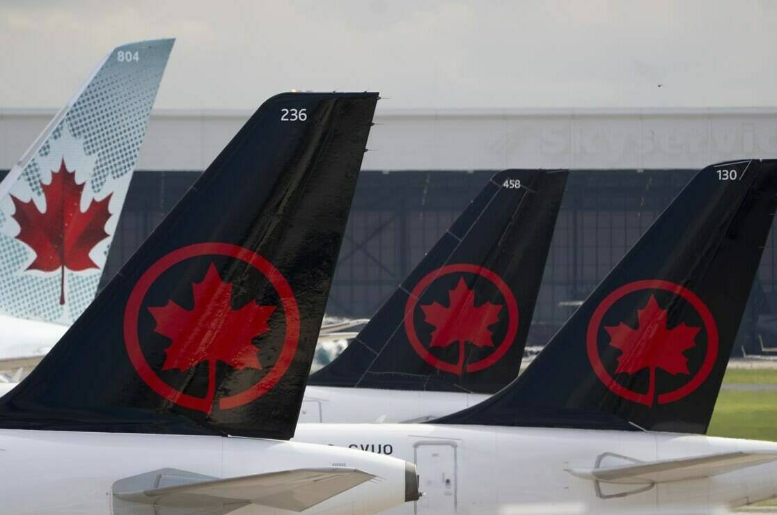 Air Canada logos are seen on the tails of planes at the airport in Montreal on Monday, June 26, 2023. Air Canada says it has reached a sponsorship deal with the soon-to-launch Professional Women’s Hockey League. The airline says it will be an inaugural premier partner and the official airline for the first six teams in the league that will have its first game on Jan. 1, 2024.THE CANADIAN PRESS/Adrian Wyld