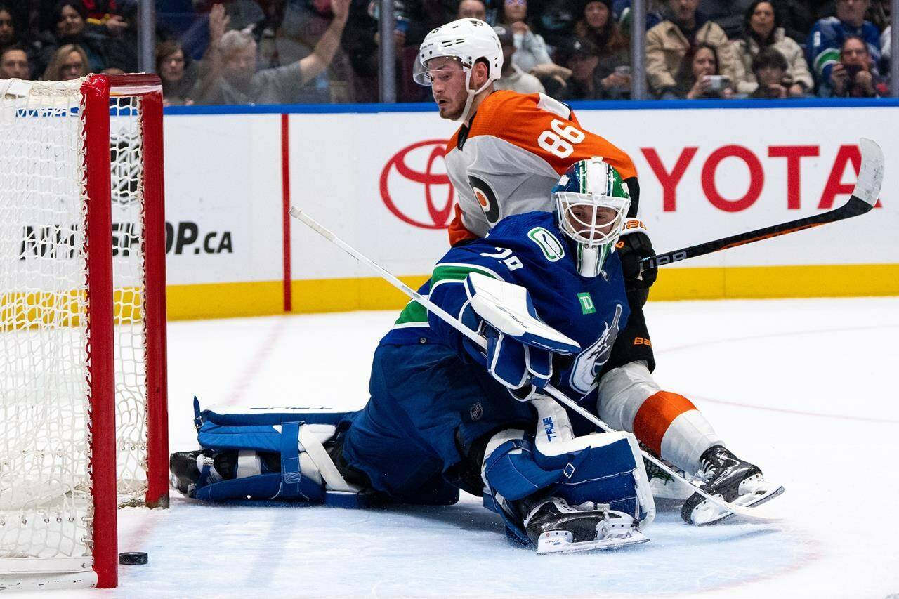Philadelphia Flyers’ Joel Farabee (86) scores on Vancouver Canucks goaltender Casey DeSmith (29) during the second period of an NHL hockey game in Vancouver, on Thursday, Dec. 28, 2023. THE CANADIAN PRESS/Ethan Cairns