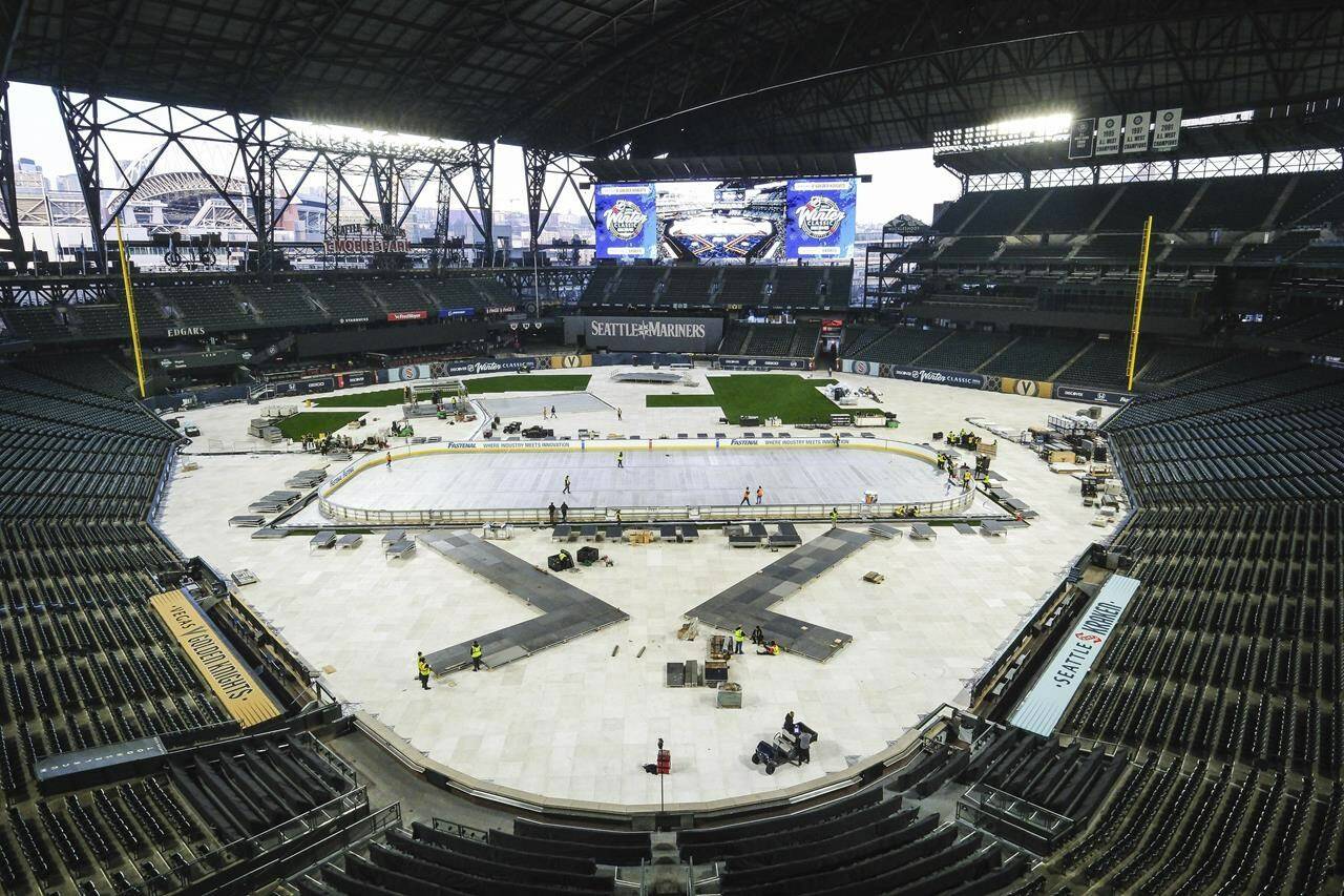 Construction continues on and around the rink for the New Year’s Day NHL hockey Winter Classic between the Seattle Kraken and the Vegas Golden Knights, Thursday, Dec. 21, 2023, in Seattle at T-Mobile Park, home of the Seattle Mariners. (Dean Rutz/The Seattle Times via AP)