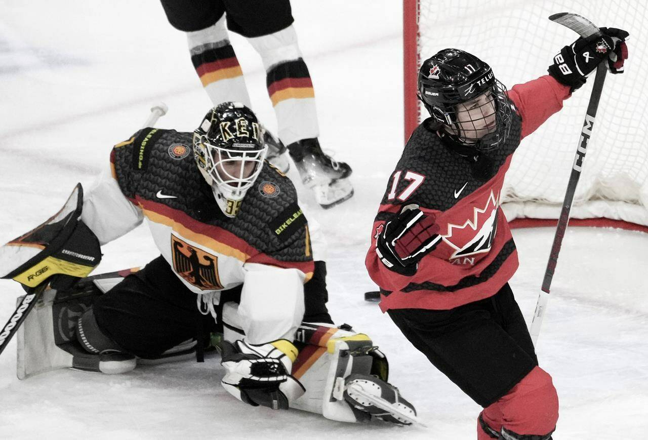 Canada’s Macklin Celebrini (17) scores on Germany goaltender Matthias Bittner (1) during first period hockey action at the IIHF World Junior Hockey Championship in Gothenburg, Sweden, Sunday, Dec. 31, 2023. THE CANADIAN PRESS/Christinne Muschi