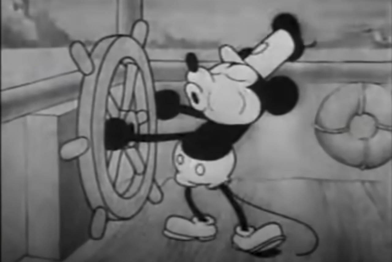 This still image from video provided by Disney shows the character Mickey Mouse in the 1928 animated short “Steamboat Willie.” On Monday, Jan. 1, 2024, the iconic character from “Steamboat Willie” entered the public domain after the expiration of the 95-year copyright, and is already the focus of two horror films. (Disney via AP)