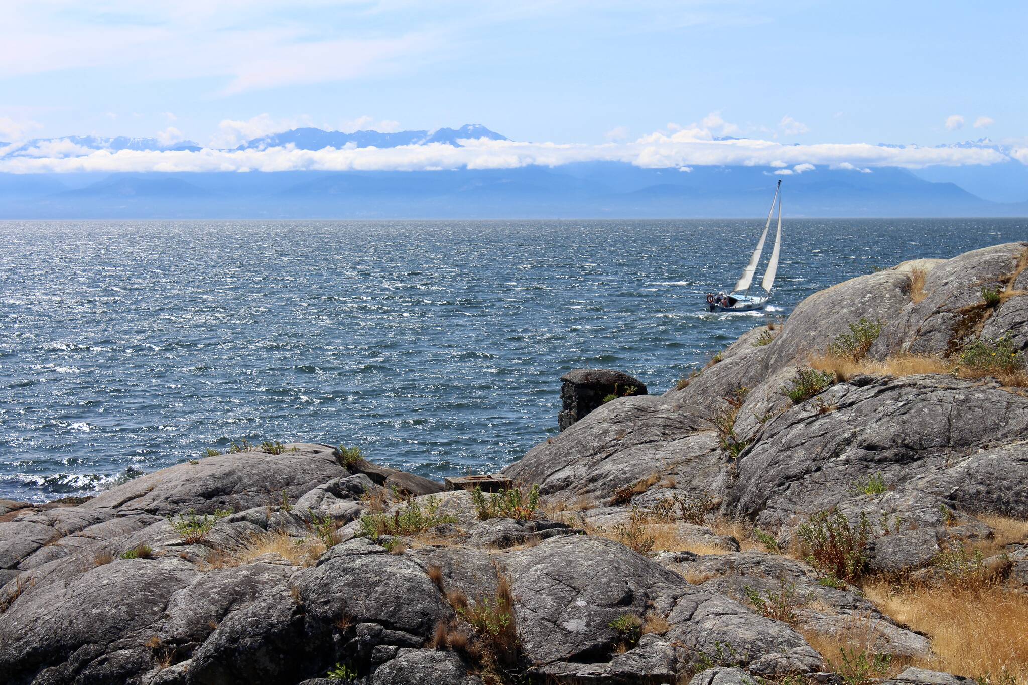 A sailboat heads west through the Strait of Juan de Fuca near Victoria on the 2020 B.C. Day long weekend. (John McKinley file)
