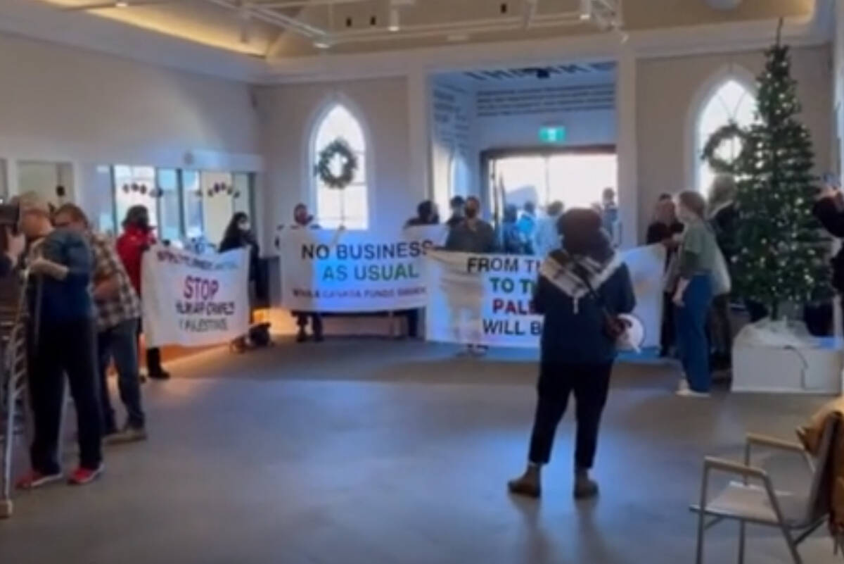 Protesters at a recent meeting to discuss the play The Runner being scheduled for the Belfry Theatre in Victoria. (Screengrab/Facebook)