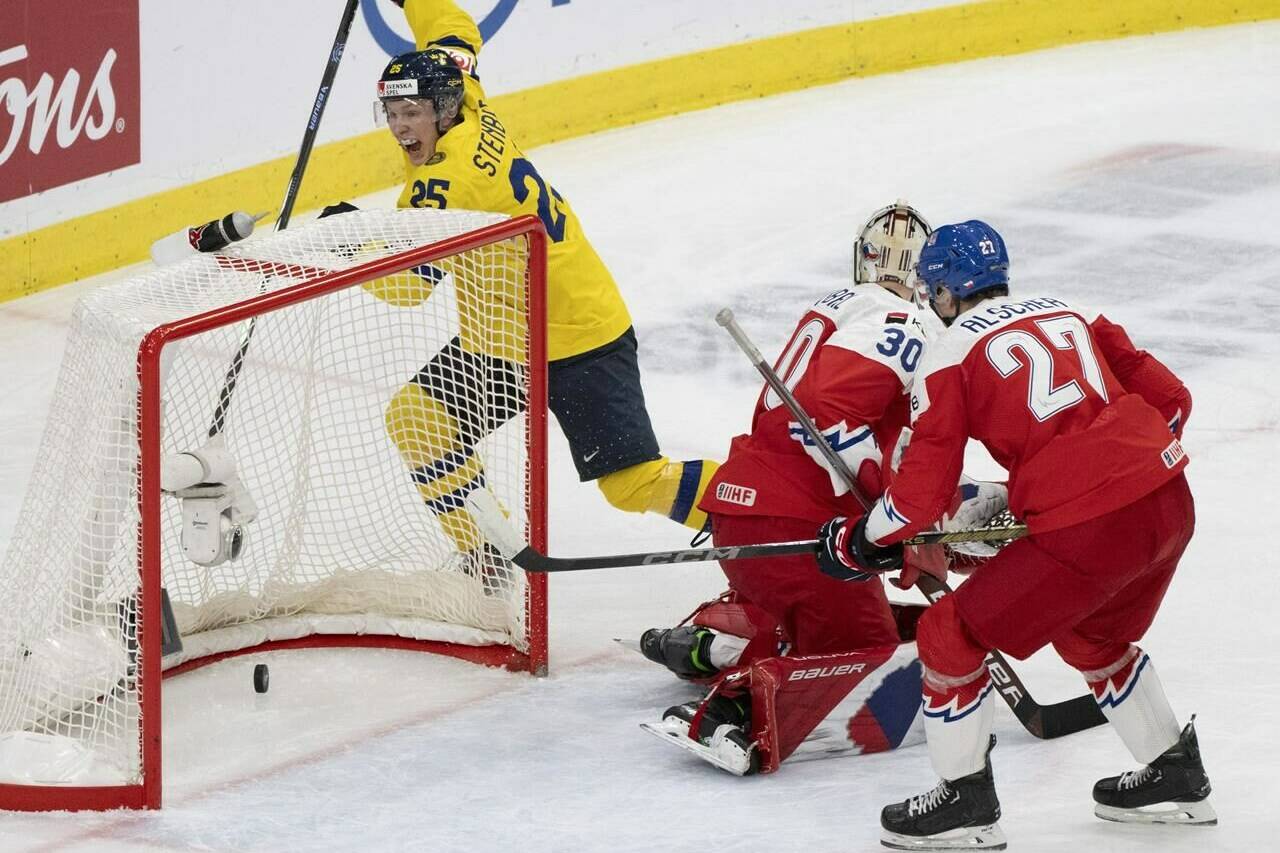 Sweden’s Otto Stenberg (25) celebrates a goal by teammate Sweden’s Theo Lindstein (not shown) in front of Czechia goaltender Michael Hrabal (30) and Marek Alscher (27) during first period semifinal hockey action at the IIHF World Junior Hockey Championship in Gothenburg, Sweden, Thursday Jan. 4, 2024. THE CANADIAN PRESS/Christinne Muschi