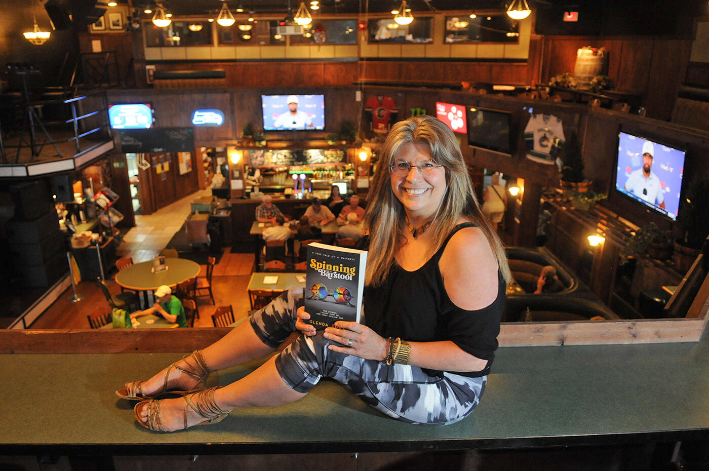 Glenda Toews, seen here at Corky’s Irish Pub in Chilliwack, wrote ‘Spinning on a Barstool’ after she was allegedly scammed $60,000 by a con artist. (Jenna Hauck/ Chilliwack Progress)