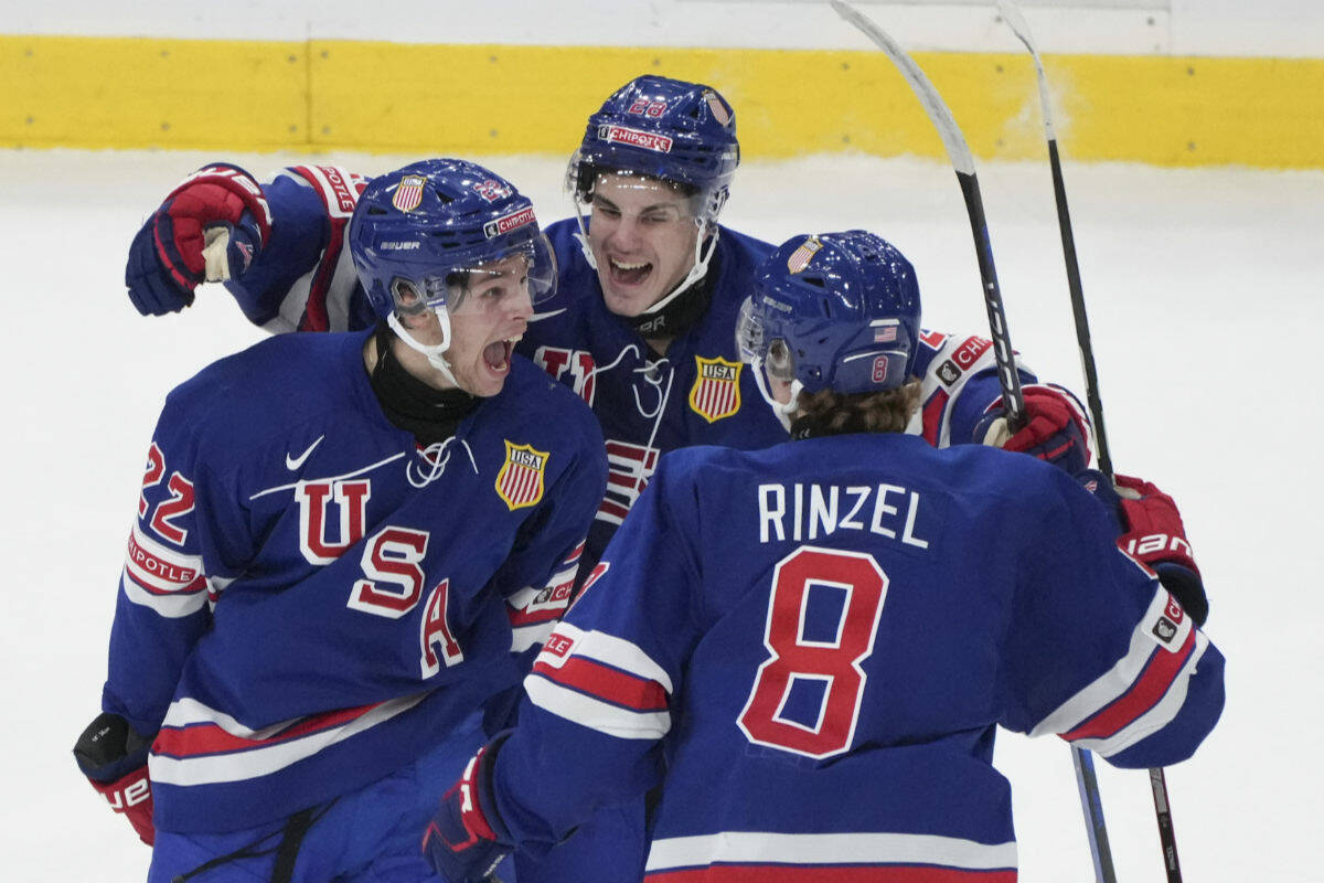 Team USA’s Isaac Howard (22) celebrates his second goal of the game on Sweden goaltender Hugo Havelid (not shown) with teammates during second period gold medal hockey action at the IIHF World Junior Hockey Championship in Gothenburg, Sweden, Friday, Jan. 5, 2024. THE CANADIAN PRESS/Christinne Muschi