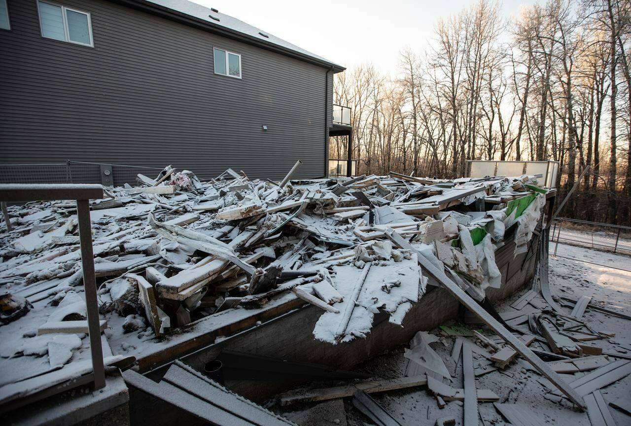 The remnants of a newly built home that was burned down and is under investigation of arson in Edmonton on Friday, Jan. 5, 2024. Police in at least three provinces are now dealing with investigations of extortion schemes with the common thread of targeting business owners in the South Asian community. THE CANADIAN PRESS/Jason Franson.