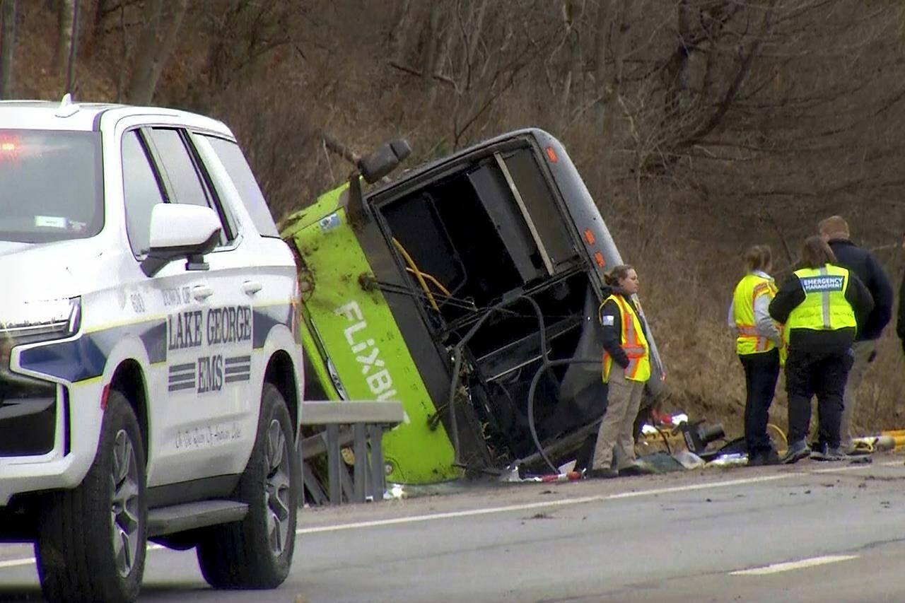 This still image from WTEN-TV video shows emergency response personnel at the site of a roll over bus accident on the Adirondack Northway, in the town of Lake George, N.Y., Friday, Jan. 5, 2024. Multiple people were injured when a tour bus carrying passengers rolled over Friday on a highway in the southern Adirondacks, New York State Police said. THE CANADIAN PRESS/WTEN-TV via AP