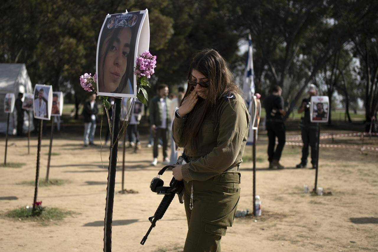 An Israeli soldier weeps at the marker for a loved one kidnapped on Oct. 7 in a cross-border attack by Hamas at the Nova music festival, after a press conference at the site in Re’im, southern Israel, Friday, Jan. 5, 2024. (AP Photo/Maya Alleruzzo)