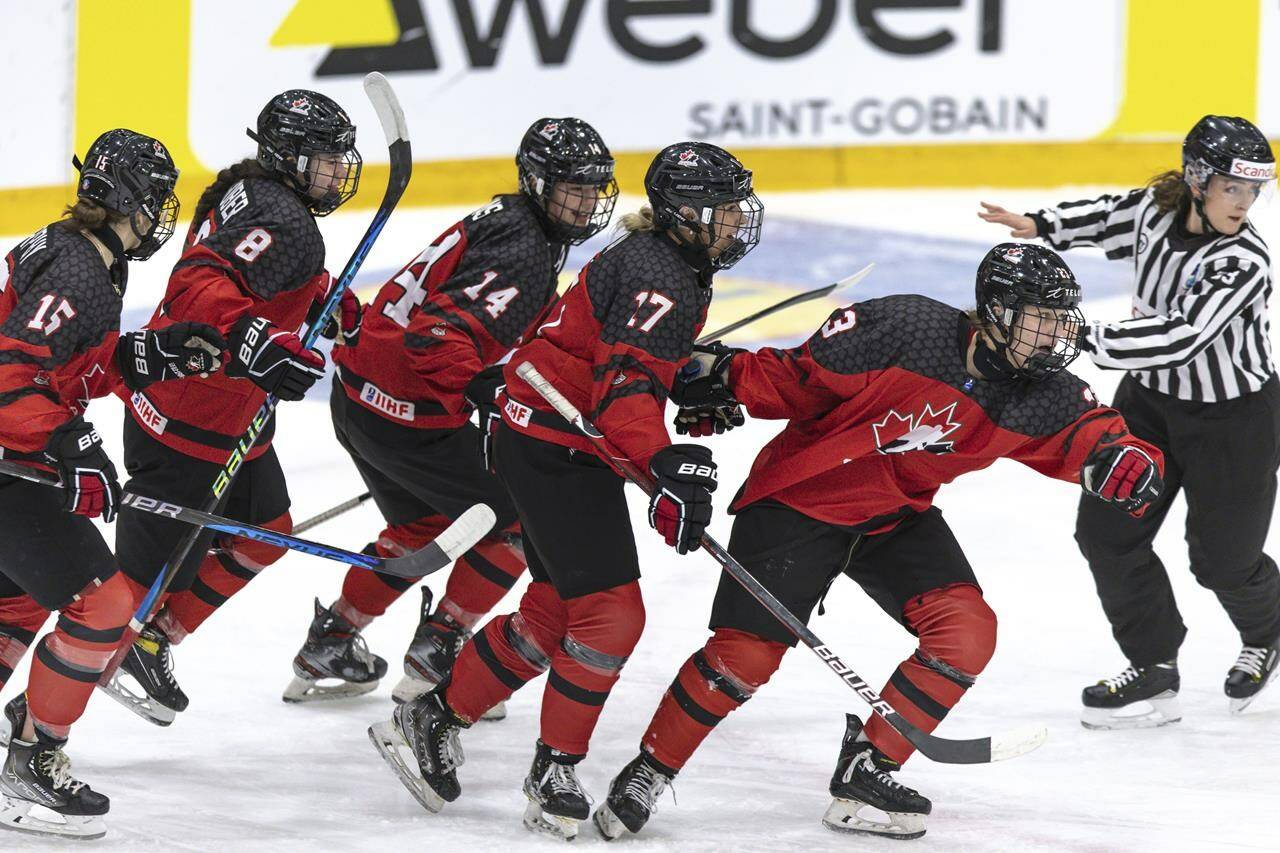 Canada’s Caitlin Kraemer, foreground right celebrates scoring with teammates from left, Ava Murphy, Piper Grober, Emma Pais and Alex Law after scoring the opening goal during the Women’s U18 Ice Hockey World Championship match between Canada and Sweden at the Ostersund Arena, in Ostersund, Sweden, Sunday, Jan. 15, 2023. THE CANADIAN PRESS/AP-TT News Agency, Per Danielsson