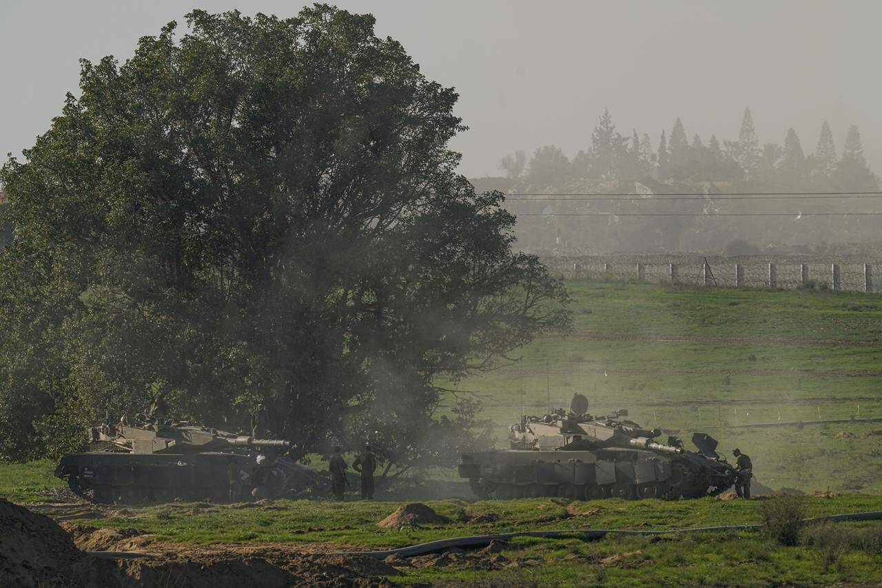 Israeli soldiers are seen near the Gaza Strip border, in southern Israel, Sunday, Jan.7, 2024. (AP Photo/Ohad Zwigenberg)
