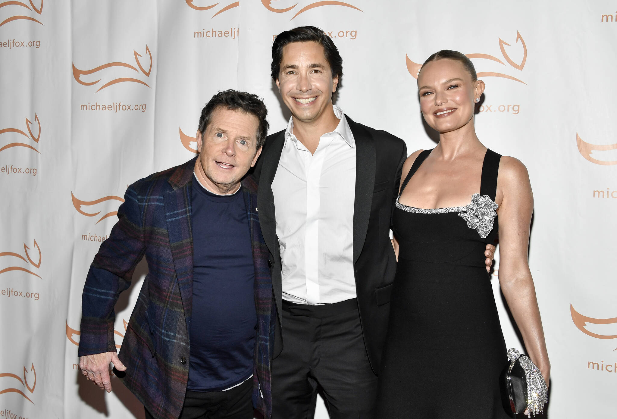 Michael J. Fox, Justin Long, left, and Kate Bosworth attend the Michael J. Fox Foundation benefit gala “A Funny Thing Happened on the Way to Cure Parkinson’s,” at Casa Cipriani, Saturday, Nov. 11, 2023, in New York. (Photo by Evan Agostini/Invision/AP)