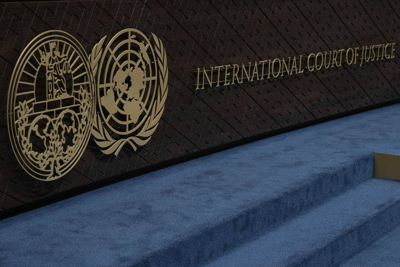 FILE - The logo of the International Court of Justice, left, and that of the U.N., right, are seen on the judges bench at the International Court of Justice, or World Court, in The Hague, Netherlands, Thursday, Oct. 12, 2023. Israel is sending top legal minds, including a Holocaust survivor, to The Hague this week to counter allegations that it is committing genocide against Palestinians in Gaza. (AP Photo/Peter Dejong, File)