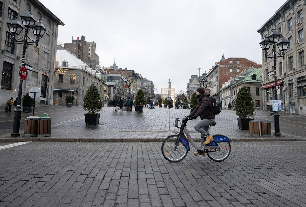 A new study suggests human-caused climate change is behind a sharp drop in spring snowpack across large parts of the Northern Hemisphere, including a swath of Ontario and Quebec. People walk on the snowless streets of Place Jacques Cartier in Old Montreal, Wednesday, Jan. 3, 2024. THE CANADIAN PRESS/Ryan Remiorz