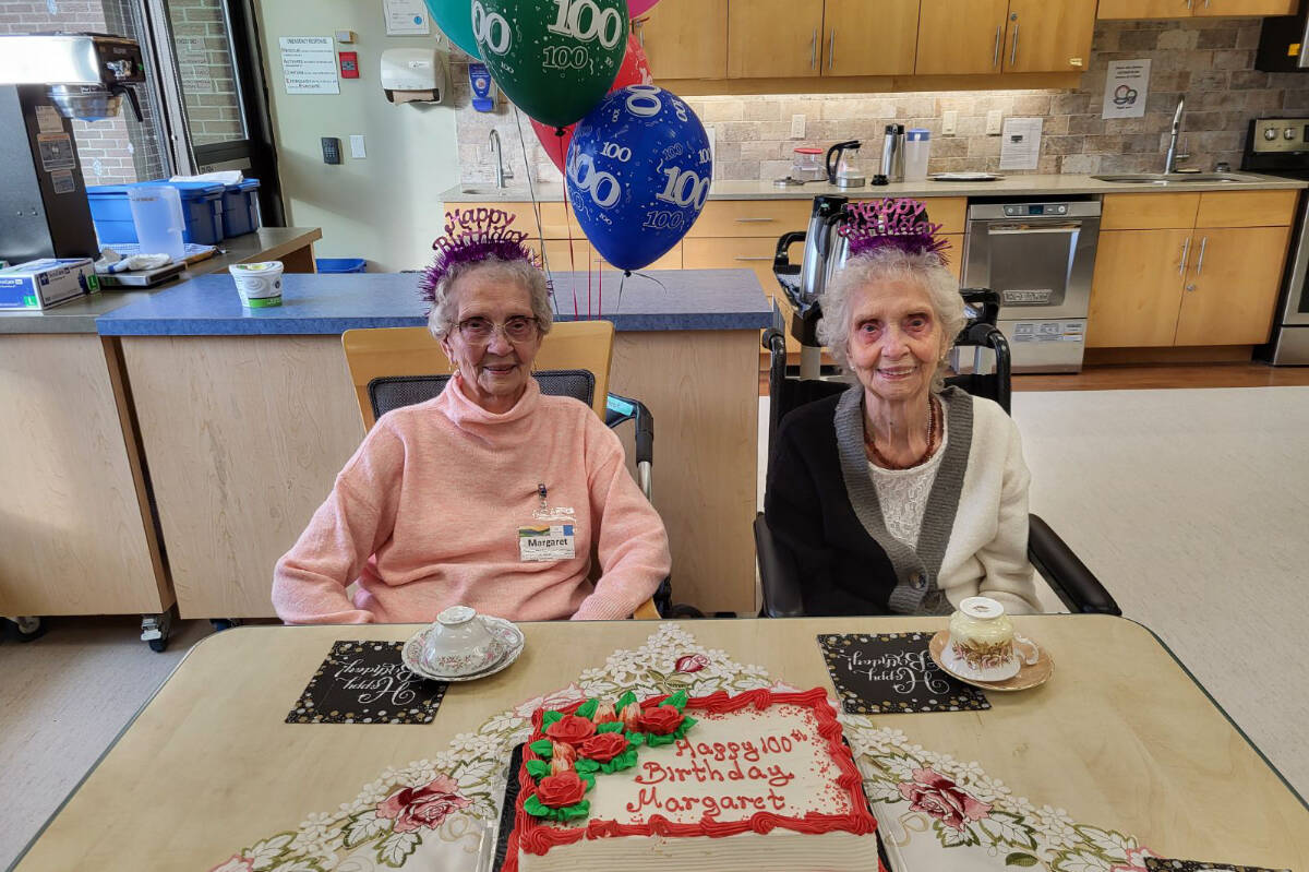 Identical twins Margaret Derry (left) and Marguerite Dahlmann, both living in Vernon, celebrate their 100th birthday with cake and coffee. The pair officially become centenarians Thursday, Jan. 11. (Roger Knox - Morning Star)