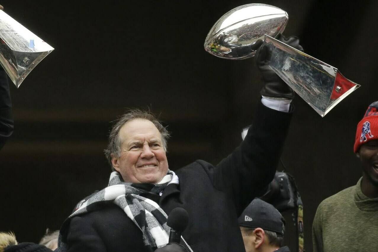 FILE - New England Patriots coach Bill Belichick holds up a Super Bowl trophy as he addresses the crowd during a rally Feb. 7, 2017, in Boston to celebrate the team’s win over the Atlanta Falcons in the NFL Super Bowl 51 football game in Houston. (AP Photo/Elise Amendola, File)