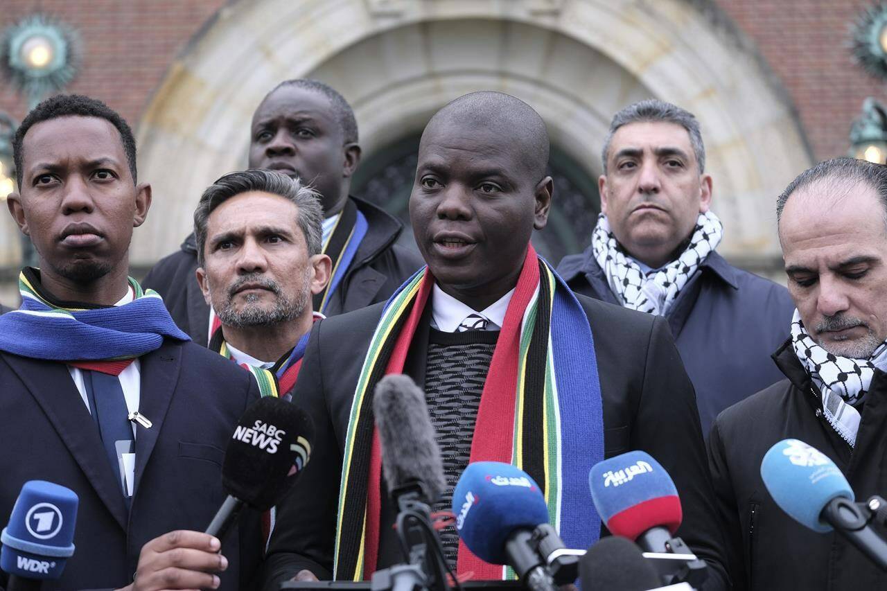 South Africa’s Minister of Justice and Correctional Services Ronald Lamola, center, and Palestinian assistant Minister of Multilateral Affairs Ammar Hijazi, right, address the media outside the International Court of Justice in The Hague, Netherlands, Thursday, Jan. 11, 2024. The United Nations’ top court opens hearings Thursday into South Africa’s allegation that Israel’s war with Hamas amounts to genocide against Palestinians, a claim that Israel strongly denies. (AP Photo/Patrick Post)