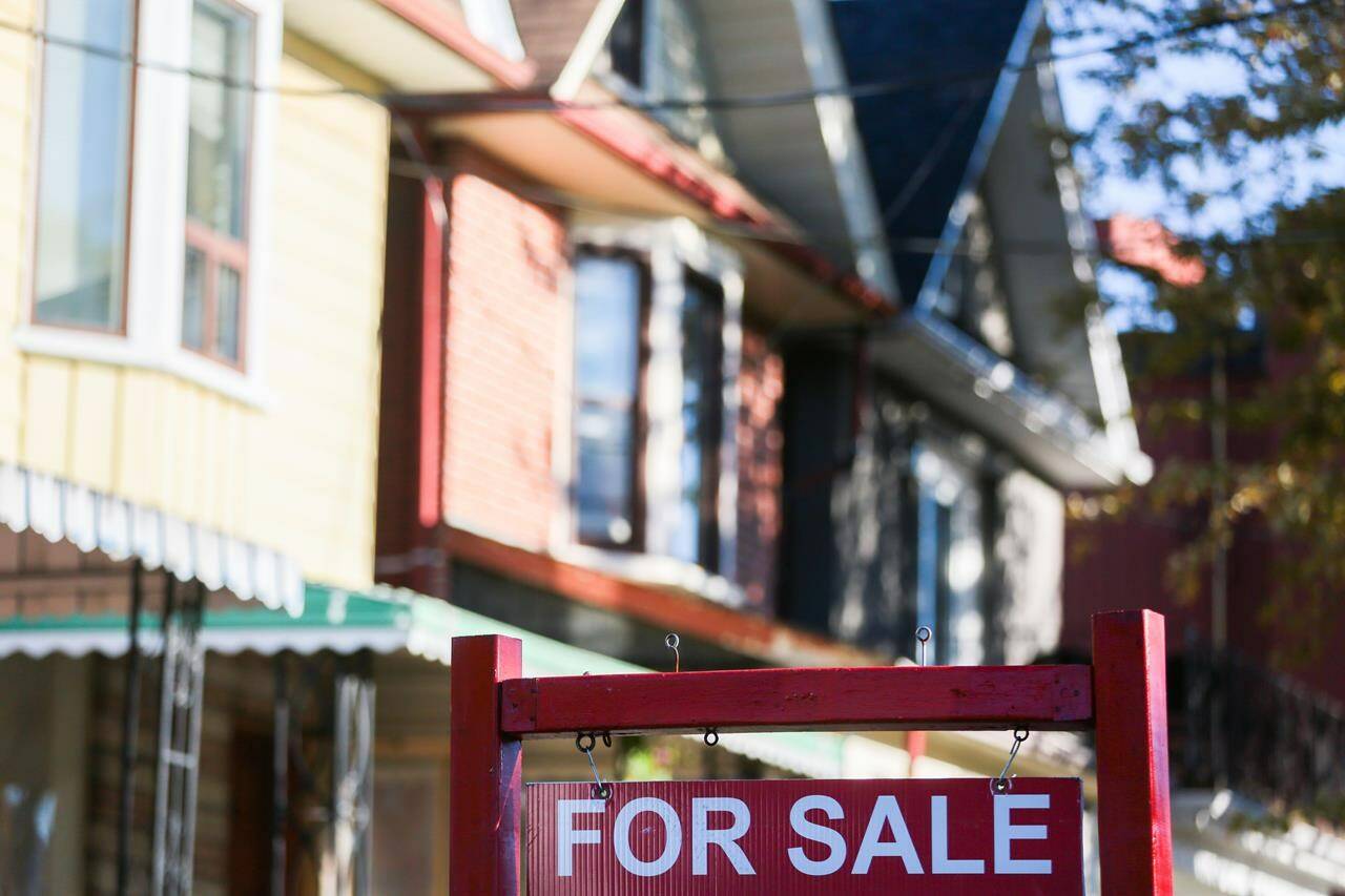 The Canadian Real Estate Association says home sales rose in December as the average price of a home sold also saw a boost compared with a year earlier. A real estate sign is displayed in front of a house in Toronto on Wednesday, September 29, 2021. THE CANADIAN PRESS/Evan Buhler